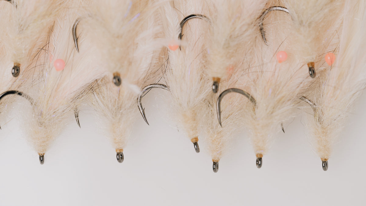 a closeup photo of a group of the Shrimp tarpon flies tied by Josh Idol at Two Aught Fly Fishing Co