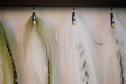 a closeup photo of a group of Beach Mullet tarpon flies from Two Aught Fly Fishing Co