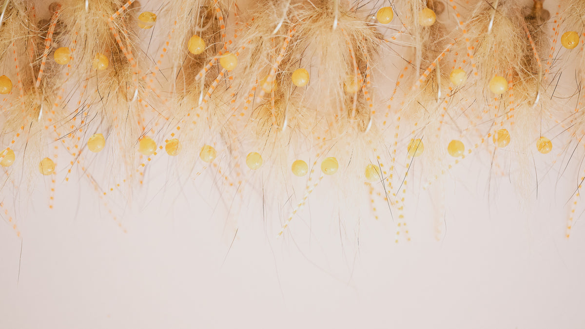 a closeup photo of a group of Coyote Crustacean bonefish flies from Two Aught Fly Fishing Co
