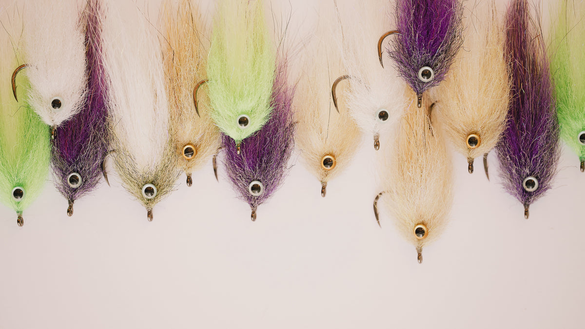 a closeup photo of a group of mullet tarpon flies from Two Aught Fly Fishing Co