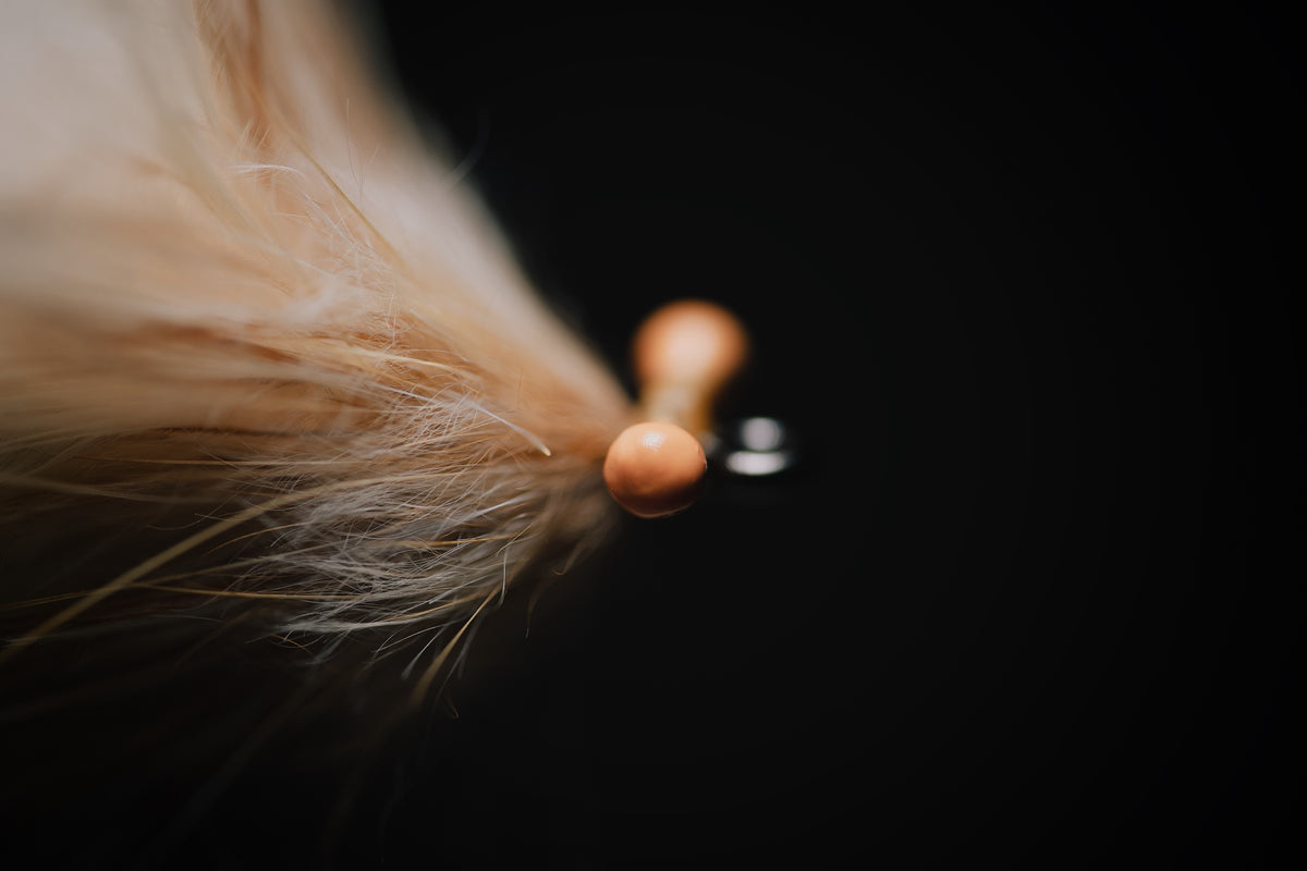 a macro photo of the handmade mono eyes on the Run Around Sue tarpon fly tied by Josh Idol of Two Aught Fly Fishing Co