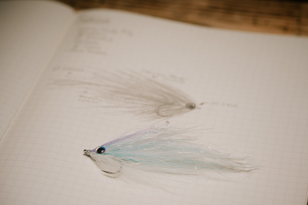 a closeup photo of the Pinfish fly tied by Josh Idol at Two Aught Fly Fishing Co resting on its corresponding page in my tying journal