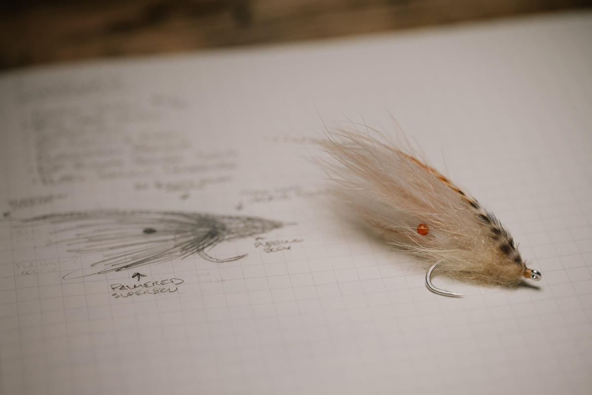 a photo of the Shrimp tarpon fly resting on its corresponding page in my tying journal