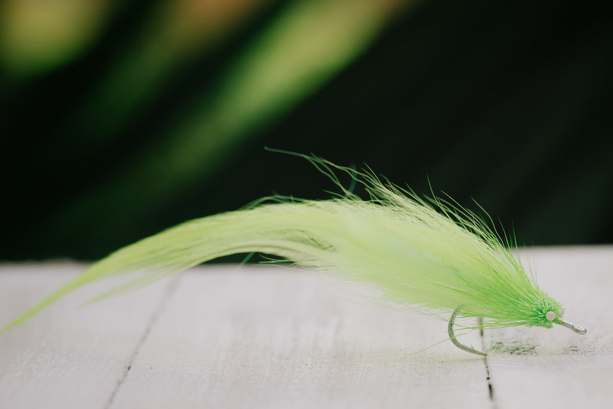 a photo of the Snake tarpon fly in chartreuse colorway tied by Josh Idol of Two Aught Fly Fishing Co