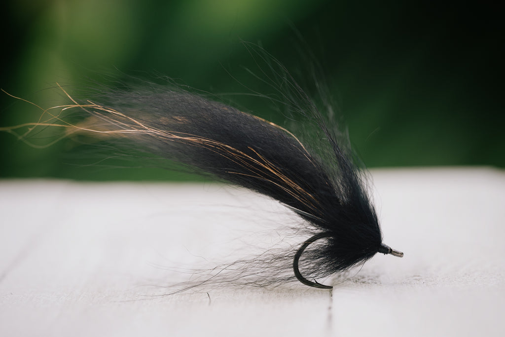 the Swamp Fox tarpon fly in black colorway tied by Josh Idol of Two Aught Fly Fishing Co