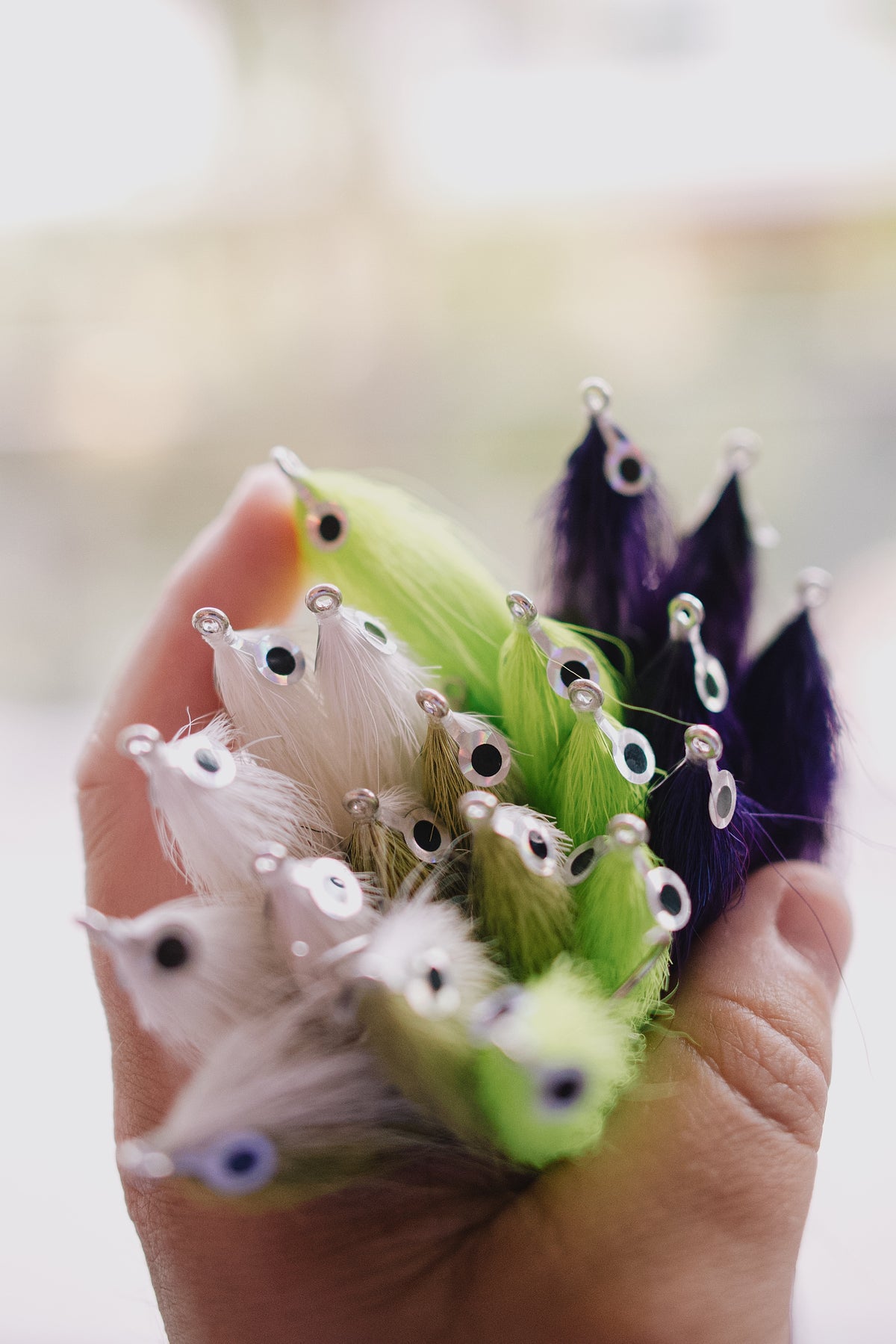 a handful of colorful Beach Mullet tarpon and snook flies from Two Aught Fly Fishing Co