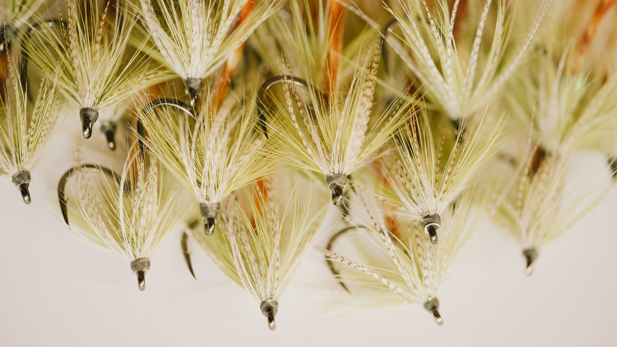 a closeup photo of a group of Worm tarpon flies from Two Aught Fly Fishing Co